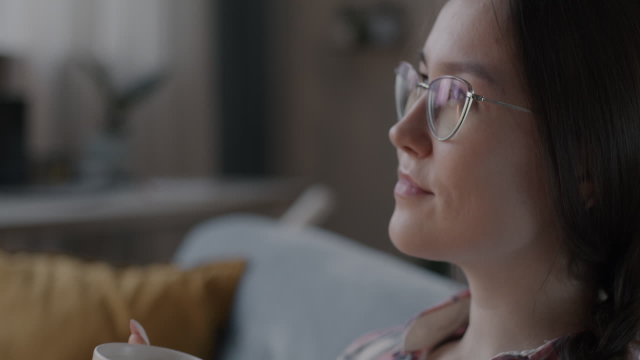 Woman Drinking Coffee or Tea on Sofa