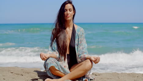 pretty young woman doing yoga at the beach