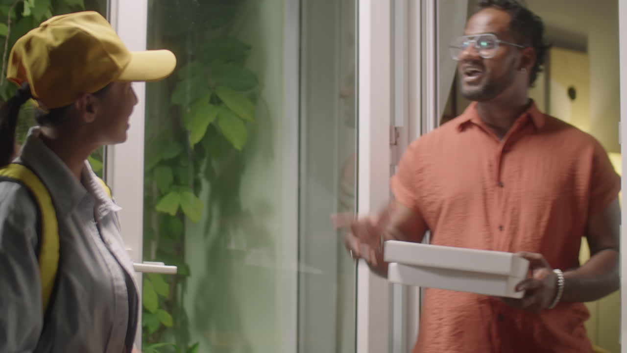 Man Receiving Pizza from Female Courier