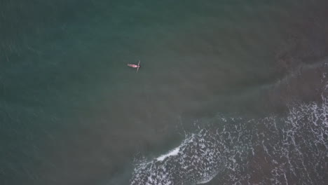 Aerial-top-shot-of-female-traveler-floating-above-sea-with-wide-reach-at-Denia-las-marinas