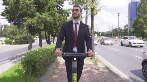 young businessman riding electric scooter outdoors.