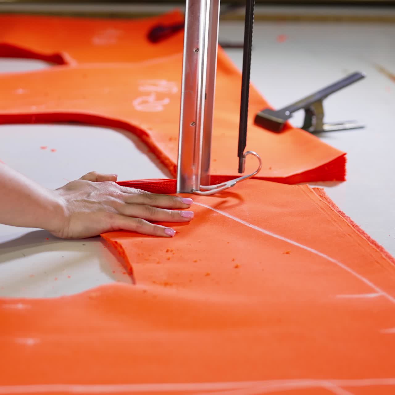Seamstress works on sewing machine. Female worker hand in textile garment manufacturers
