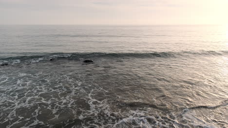 reminiscing on the shoreline beach of big rock malibu california at soothing golden hour