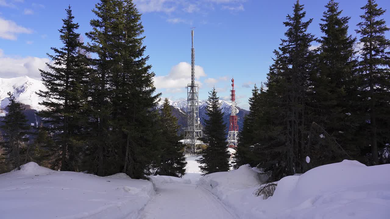 Radio, mobile and telecommunications masts and structures on a snow covered mountain near the border between Italy and Austria