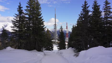 radio, mobile and telecommunications masts and structures on a snow covered mountain near the border between italy and austria