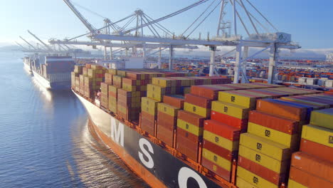 Close up aerial view of containers stacked on cargo ship in large international port, Oakland USA
