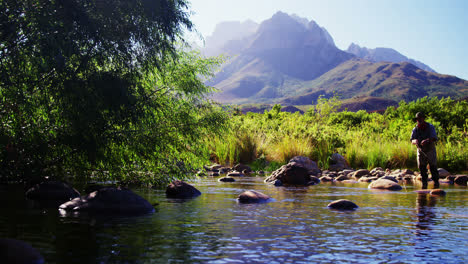 man fly fishing in river