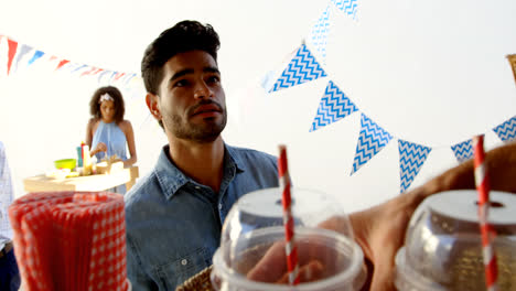 waiter serving juice to customer