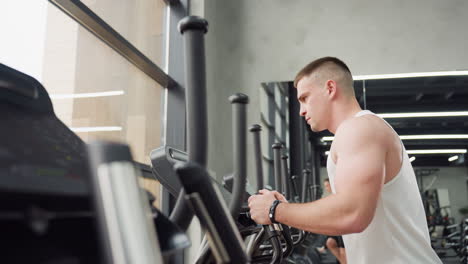 muscular runner intensely focusing on treadmill console in bright modern gym with large window and mirror reflecting other athletes powering through cardio with dynamic pace and determined expression