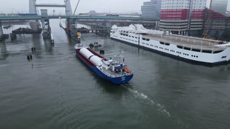 construction of hisingsbron bridge, vertical-lift bridge in gothenburg, sweden - parts being delivered by a cargo ship in gota river - high angle shot