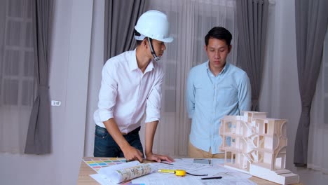 two business men or engineers on an architectural model