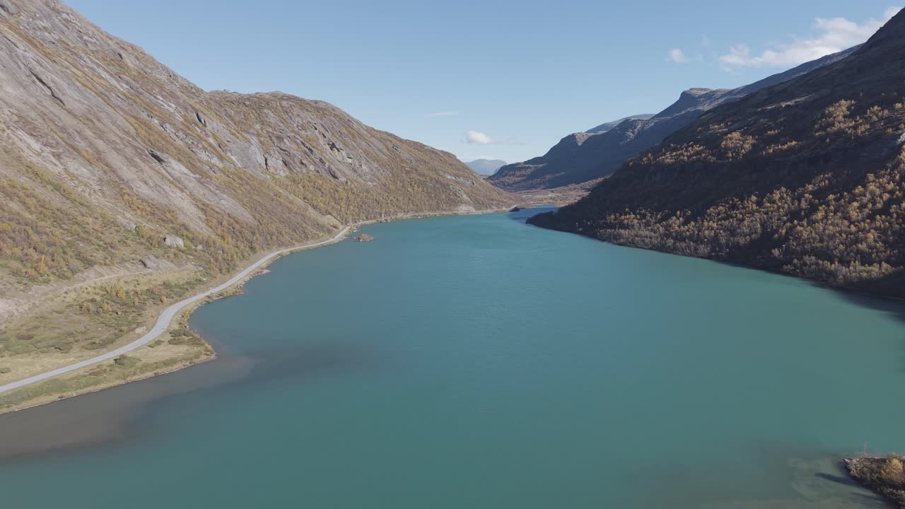 Turquoise green glacier lake in Jotunheimen National Park, Norway. Forwards flying drone footage