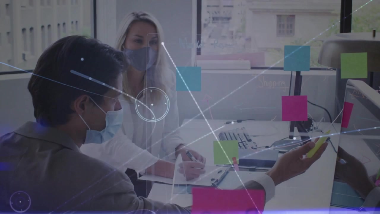 Man lifting yellow pen at glass notes, woman noting, HUD overlays flaring between them for business