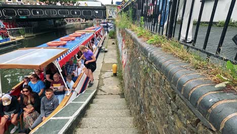 tourists enjoy a canal boat ride in london