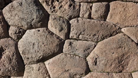 a close-up video showcasing the incredible precision and artistry of a historic inca wall in cusco, peru. the mortar-less, interlocking construction of this ancient civilization's masterful stonework