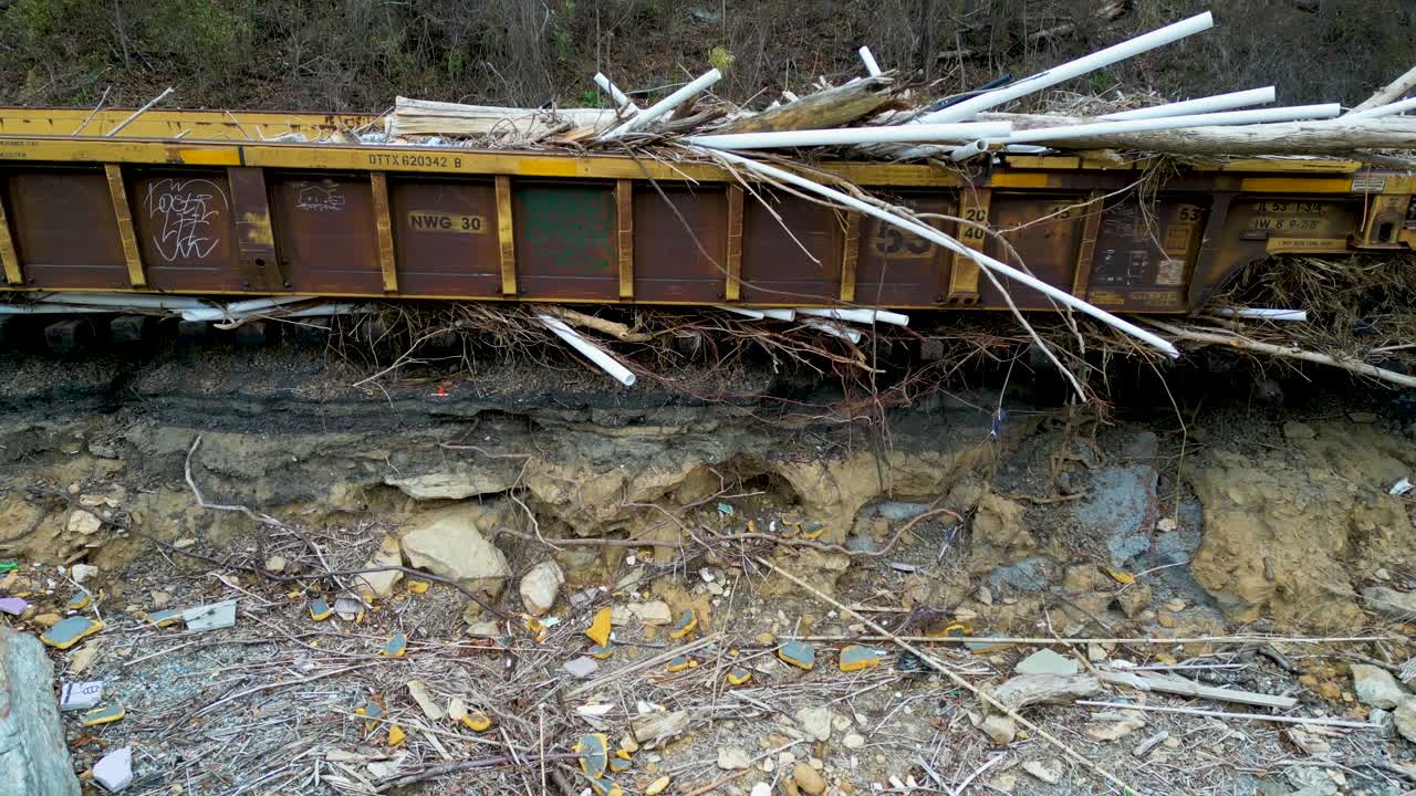 4K Aerial Drone Video of Train Loaded with Debris and Stranded On Tracks Damaged by Hurricane Helene Along the French Broad River near Marshall, NC (2024)