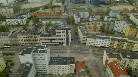 Aerial,-drone-slowly-tilting-up-from-residential-district-towards-Sea-towers-Gdynia-and-city-port-view