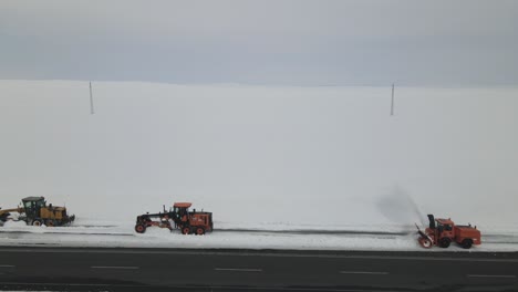 snow covered highway working machine