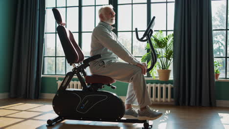 senior man exercising on stationary bike