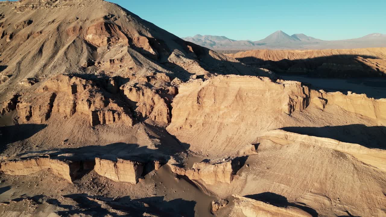 Drone shot showcasing the arid expanse of Chile’s moon valley, illuminated by fading evening light