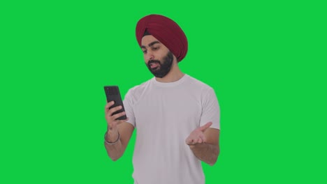 Sikh-Indian-man-talking-on-video-call-Green-screen