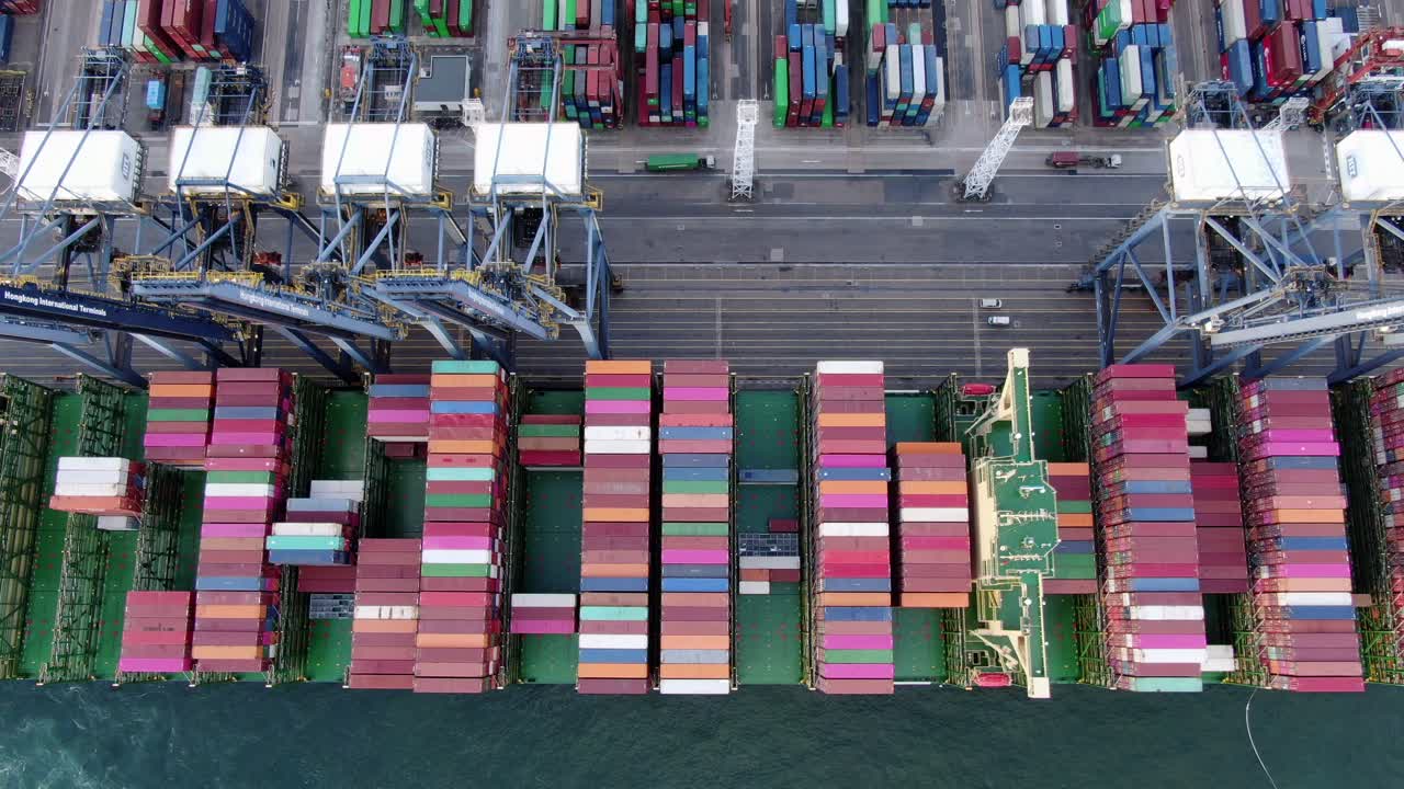 Mega Container Ship docked at Hong Kong port, during loading and unloading operation, Aerial view