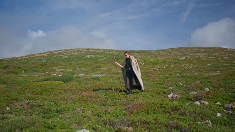 carefree traveler exploring nature walking grassy hill. serene woman outdoors