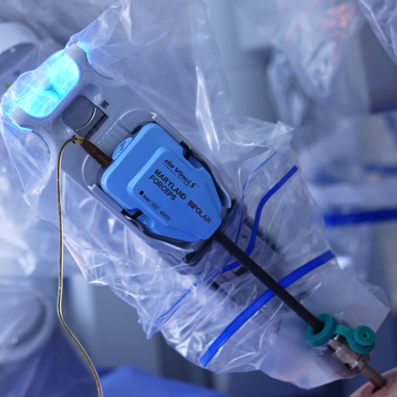 Technological robotic arm covered with plastic moves in the patient's abdomen. Da Vinci robot perform minimum invasive operation. Close up