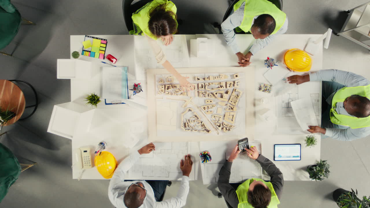 Vertical Video Top down view zoom in of real estate developers and architects in office