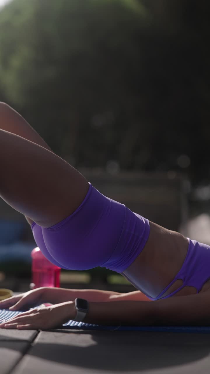 Woman doing a bridge pose workout outdoors