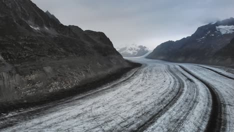 flyover over the longest glacier in the alps - the aletsch glacier in valais, switzerland -from side to side on a cloudy day