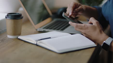 close up businessman hands using smartphone browsing research information online writing creative ideas in journal diary brainstorming entrepreneur enjoying relaxed coffee shop cafe