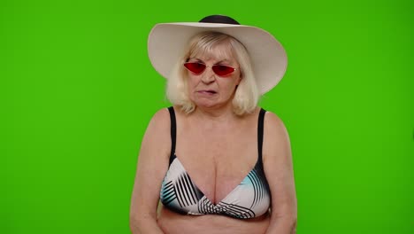 Angry-irritated-senior-old-woman-tourist-in-swimsuit-bra,-making-bored-face,-upset,-tired,-unhappy