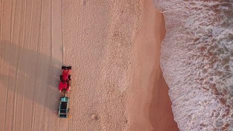 aerial shot of beach tracktor cleaning manly beach