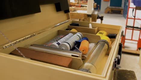 construction tools inside a wooden suitcase