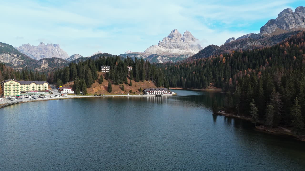 Misurina Lake with Tre Cime di Lavaredo peaks in the Italian Dolomites, serene autumn scenery