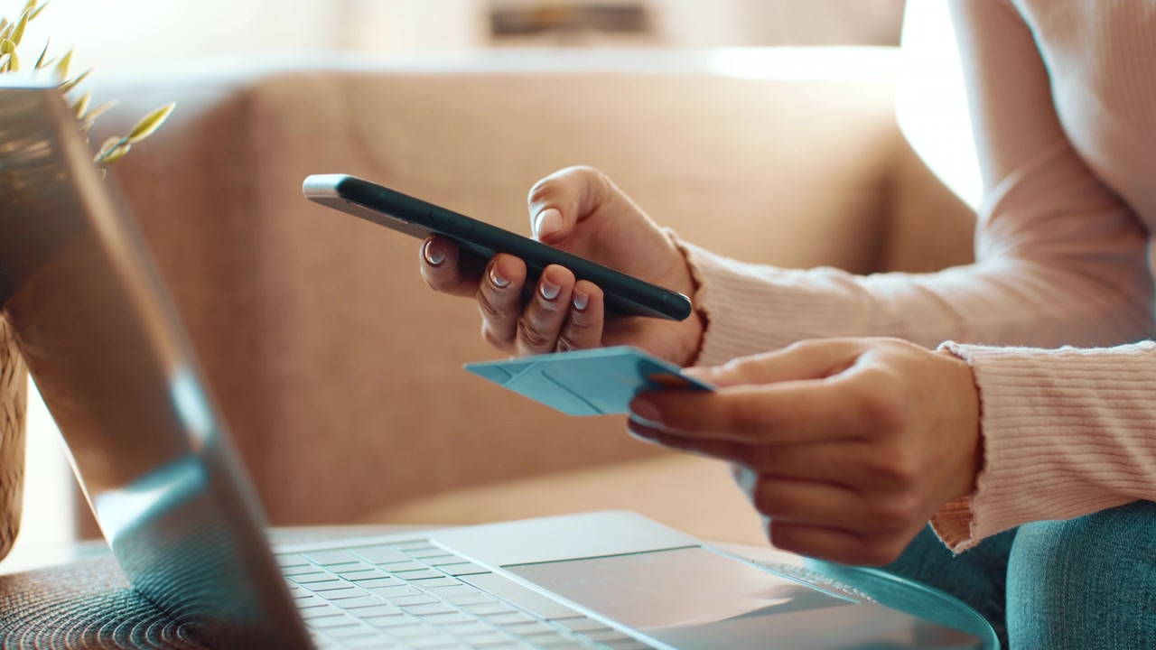 Woman Shopping Online Using Smartphone and Credit Card