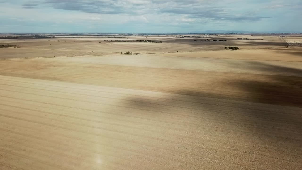 Drone view over dry paddocks after harvest near Wedderburn, Victoria, Australia, May 2021.
