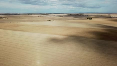 drone view over dry paddocks after harvest near wedderburn, victoria, australia, may 2021.