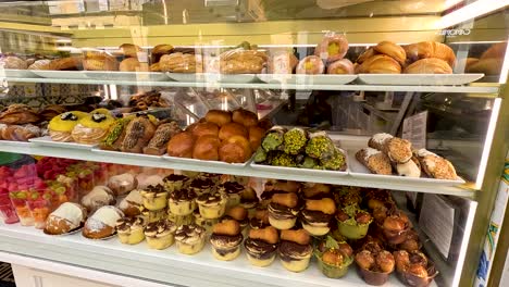 assorted pastries and breads in a bakery display