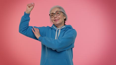 Senior-old-granny-woman-showing-biceps,-looking-confident-feeling-power-strength-to-fight-for-rights