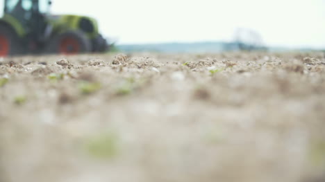 agriculture slowmo shoot of agricultural tractor sowing and cultivating field