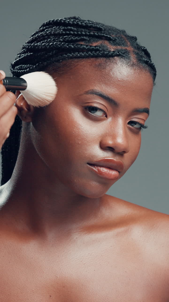 Young Black Woman Applying Makeup with a Brush
