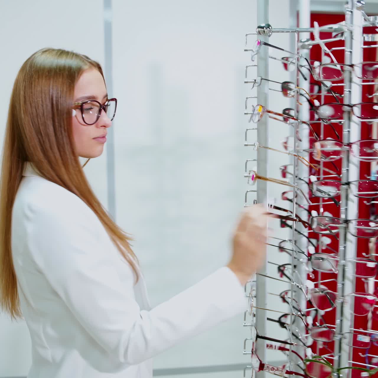 Lady choosing pair of glasses