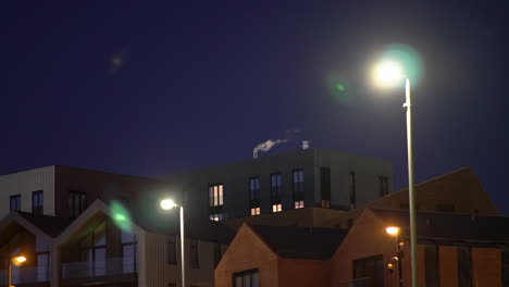 Slow-Motion-Urban-architecture-at-night-with-smoke-coming-out-of-a-chimney,-London-UK