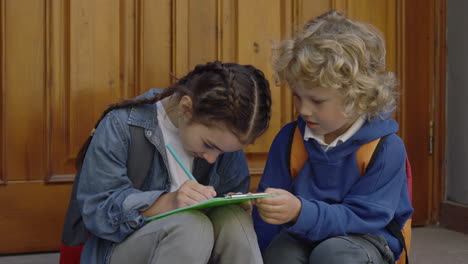 children doing homework together outside