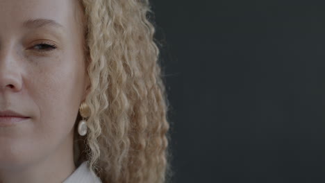 close-up portrait of a woman with curly blonde hair