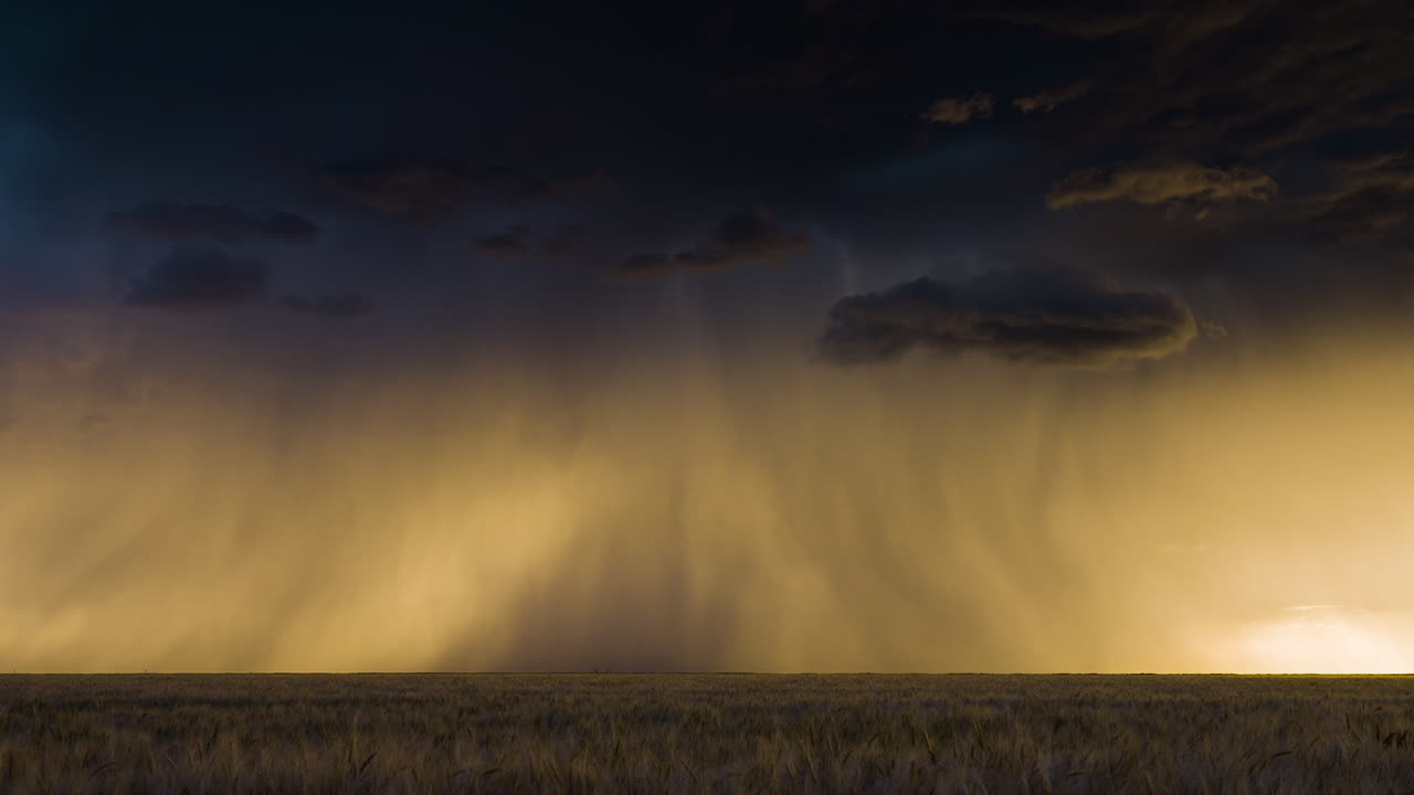 Lightning strikes flicker below a beautiful storm at sunset