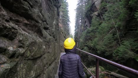 a woman in a yellow hard hat explores breathtaking landscapes in this video a woman in a yellow hard hat explores stunning natural landscapes from majestic canyons to serene forest paths blending adventure and tranquility