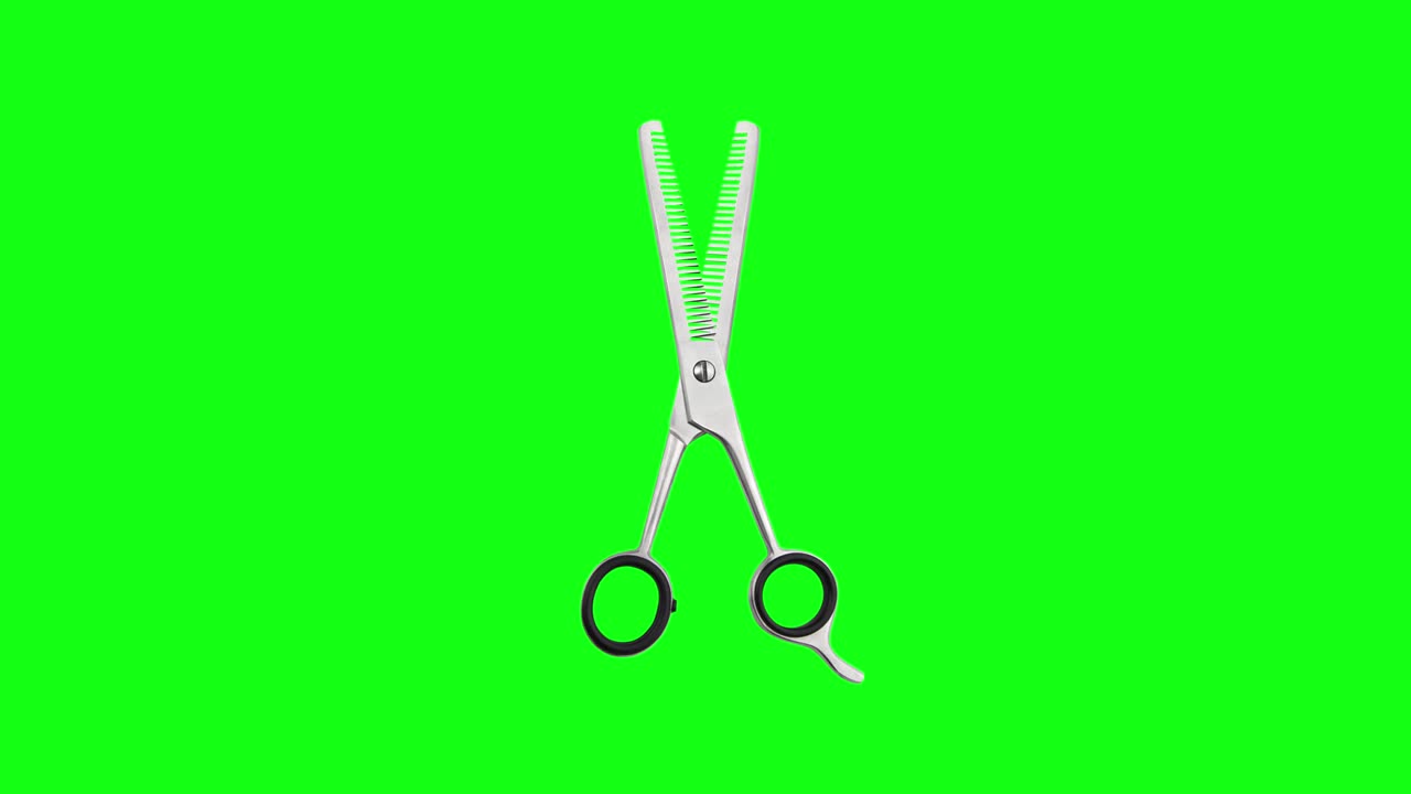 Hairdressing scissors with black handles on green chromakey